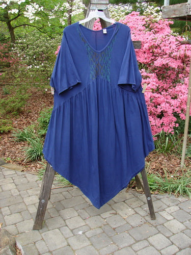 Barclay Short Sleeved Dubuffet Dress Spirograph Royal Size 2 displayed on a rack, showcasing a gathered front, pointed hemline, and three-quarter sleeves with vertical pinched seams.