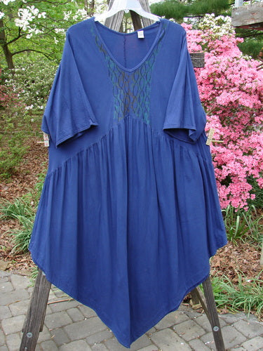 Barclay Short Sleeved Dubuffet Dress with Spirograph pattern displayed on a rack, highlighting its gathered front and dramatic pointed hemline.