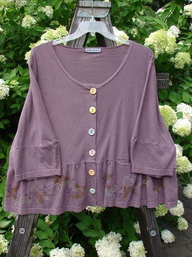 Barclay Peplum Pocket Jacket Magic Garden Dusty Plum Size 2 displayed on a wooden fence, showcasing its ceramic buttons, peplum detail, and three-quarter sleeves, reflecting BlueFishFinder's vintage aesthetic.