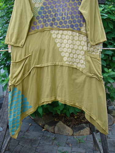 Barclay Raw Seam Vector Tunic Dress Sectional Daisy Yellow Olive Size 0, showcasing raw edges, a V-shaped neckline, empire waist, fluttery sleeve edges, and a unique daisy pattern, emphasizing its artistic design.