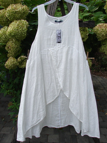 Barclay NWT Linen Tulip Midlayer Overpiece Unpainted White Size 0 features a sleeveless, scoop-neck design with an asymmetrical layered front hem, ideal for warm weather and showcasing BlueFishFinder's creative, vintage-inspired aesthetic.