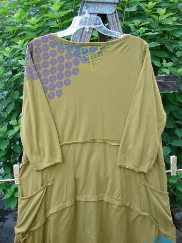 Barclay Raw Seam Vector Tunic Dress Sectional Daisy Yellow Olive Size 0 with purple floral pattern, featuring raw edges, variable hemline, and fluttery sleeve edges, perfect for expressing individuality.