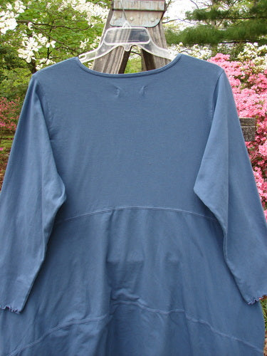Barclay NWT Cotton Lycra Shape Dress Unpainted Indigo Size 2 displayed on a clothes rack, showcasing long cozy sleeves, rounded neckline, deep inseam side pockets, and a varying hemline.