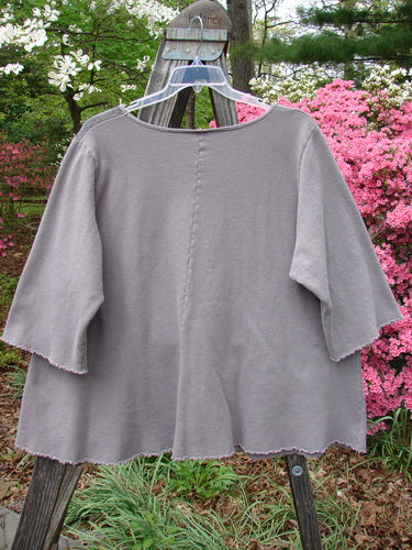 Barclay Fleece Cafe Sweatshirt Poet Garden Shaunting Stone Size 2 displayed on a wooden hanger, featuring a rounded neckline, three-quarter sleeves, front cargo pockets, flared hemline, and curly edgings.