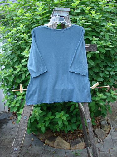 Barclay Slub Three Quarter Sleeved Cafe Tee Unpainted Tealen Size 1 displayed on a wooden rack, highlighting its rounded neckline, slight A-line flare, and curly edgings, embodying Bluefishfinder.com's vintage aesthetic.