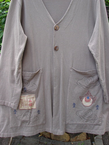 1999 Triangle Jacket Far Eastern Shale Size 1 features a long grey design with oversized front painted pockets, deep V neckline, and a drawcord back, embodying Bluefishfinder.com's vintage style.
