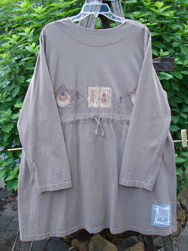 1999 Triangle Jacket Far Eastern Shale Size 1 features a medium-weight organic cotton with two oversized front pockets, deep V neckline, and drawcord back, showcasing intricate Far Eastern-themed paint details.