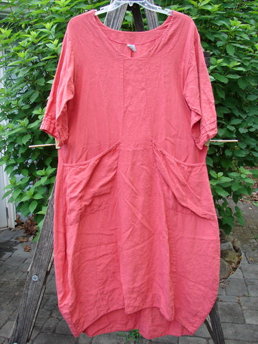 Barclay Linen Ceremony Tea Thostle Dress Summer Unpainted Geranium Size 0, featuring a scooped neckline, hourglass shape, upward scoop front hemline, and pleated pockets, displayed on a clothesline.