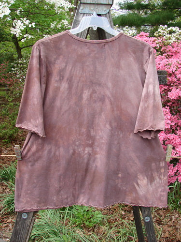 Barclay Three Quarter Sleeved Cafe Tee Vase Mottled Mushroom Size 2 hanging on a clothesline, showcasing its slightly textured slubbed organic cotton fabric and three-quarter sleeves.