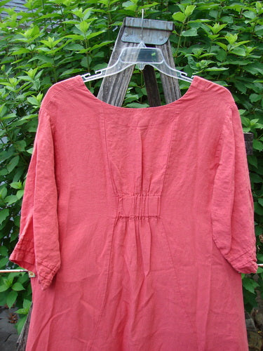 Barclay Linen Ceremony Tea Thostle Dress in Geranium on a swinger, showcasing its hourglass shape, pleated pockets, and three-quarter bell sleeves, embodying Bluefishfinder.com's vintage aesthetic.