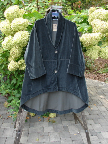 Barclay NWT Velvet Opera Pocket Coat in Unpainted Blue Black features a shawl collar, three-quarter sleeves, and a high-low hem, elegantly displayed outdoors on a wooden stepladder.