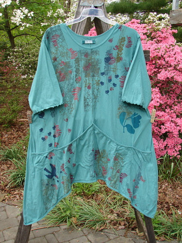Barclay Three Quarter Sleeved Quad Pocket Tunic Forest Garden Jade Size 2 featuring a floral pattern, four drop pockets, and three-quarter wide sleeves.