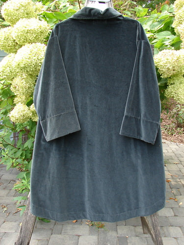 Barclay NWT Velvet Opera Pocket Coat in Unpainted Blue Black, size 0, displayed outdoors. This knee-length coat features a luxurious heavier-weight cotton velvet texture, highlighting its elegant design and craftsmanship.