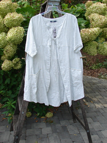 Barclay NWT Linen Contrast Tie Pocket Cardigan, Field Twig Dew Size 0, draped on a wooden A-frame. Features a shallow V-neck, tie closure, front patch pockets, and a slightly gathered waist.