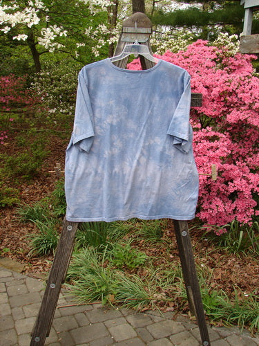 Barclay Short Sleeved Tee Bird Cage Mottled Sky Size 2 displayed on a wooden rack, showcasing its rounded neckline, drop shoulders, and boxy shape.