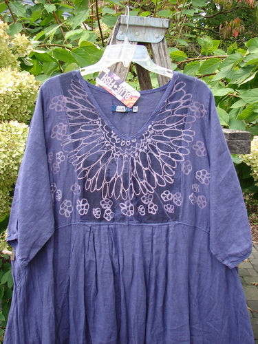 Barclay NWT Linen Process Two Story Dress Mum Ultra Violet Size 0, featuring a hand-drawn print on the neckline and floral motifs, hangs outdoors showcasing its loose fit and lightweight linen fabric.