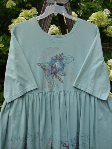 Barclay Flower Garden Tunic Dress Dragonfly Aloe Size 2, featuring a ceramic three-button front, open lower front, full pleated skirt, sweeping A-line shape, rounded neckline, and painted dragonfly design.