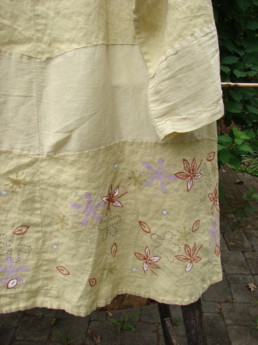 Barclay Linen Wonderland Sectional Banded Cardigan Daisy Chain Celery Size 1 features a scooped neckline, belled sleeves, pearly buttons, and whimsical daisy chain pattern, highlighting its creative vintage appeal.