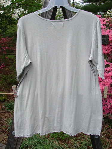 Barclay Three Quarter Sleeved Textured A Line Tee Wild Cat Live True Cloud Size 2 hanging on a clothesline outdoors, showcasing its rounded neckline and generous A-line shape.