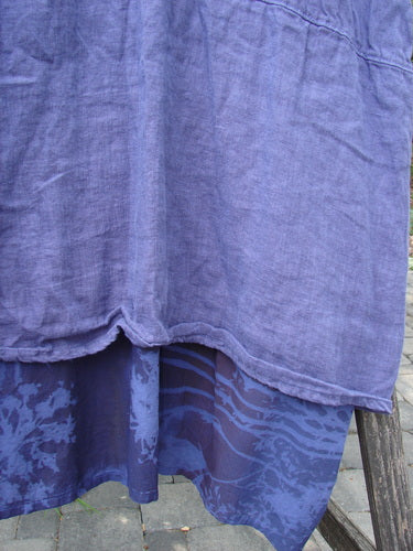 Barclay NWT Linen Process Two Story Dress Mum Ultra Violet Size 0, featuring a light blue linen top layer and darker abstract print percale underskirt, hanging outdoors, showcasing its elegant design.