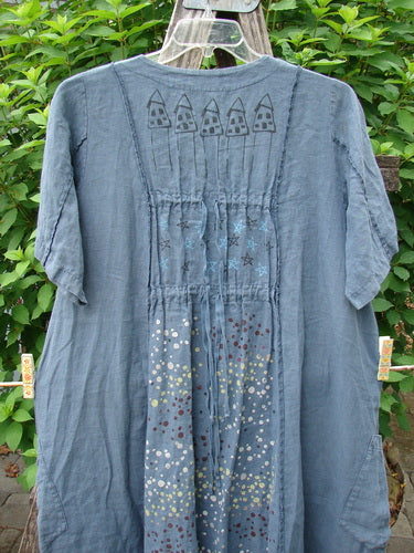 Barclay Linen Double Tie Back Jacket Star Rain Blue Mineral Size 0 features a deep V-neckline, short sleeves, A-line sweep, front pockets, and exterior vertical stitchery, showcasing the unique star rain theme.