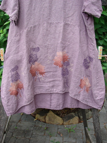 Barclay Linen Urchin Dress Necklace Leaf Dusty Plum Size 0, showcasing a delicate floral pattern and a unique painted hemline, embodies BlueFishFinder's creative vintage style. Made from medium-weight linen with a distinct reverse bell shape.