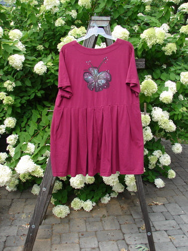 Barclay Boxcar Dress Rear Blossom Cranberry Size 2 features a pink dress with a butterfly design, an empire waist seam, wide full pleats, and a lower flared hem.