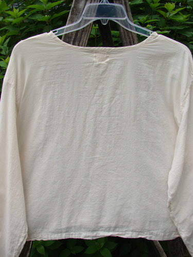 1999 Batiste Boxy Top Unpainted Natural Size 2 displayed on a rack, showcasing its rounded neckline, tiny side vents, and billowy sleeves, embodying Bluefishfinder's vintage style and creative freedom ethos.