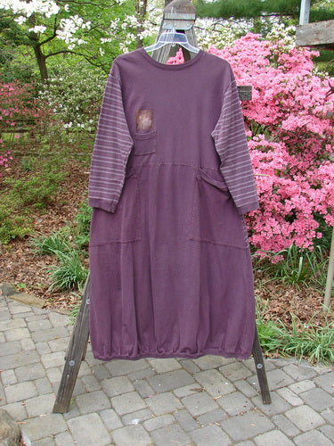 1999 Teacher's Dress Forest Sprig Blackberry Stripe Size 2 displayed on a rack, showcasing gathered elastic ribbing on cuffs, neckline, hemline, and large wrap-around pockets, highlighting its unique contrast of prints and theme.