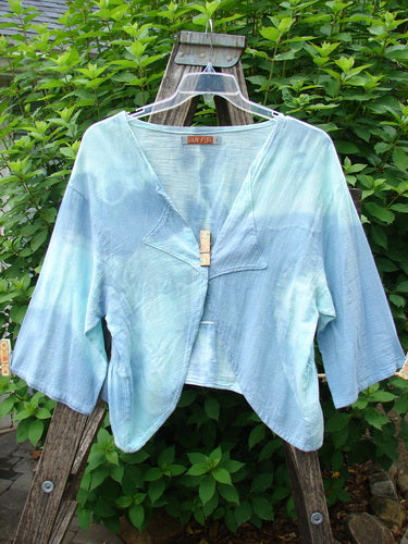 Barclay Gauze Open Front Shrug Mottled Sky Size 1 displayed on a swinger, showcasing its open front, reverse triangular upper panels, three-quarter sleeves, and flowing hemline, embodying BlueFishFinder's vintage charm.