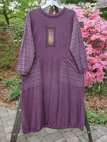 1999 Teacher's Dress Forest Sprig Blackberry Stripe Size 2 on a clothes rack, featuring unique contrast prints, gathered elastic ribbing, exterior wrap-around pockets, and a tiny ribbed painted pocket on the back.