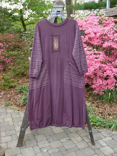 1999 Teacher's Dress Forest Sprig Blackberry Stripe Size 2 on a rack, showcasing unique contrast prints, gathered elastic ribbing, and two exterior wrap-around pockets, perfect for expressing individuality.