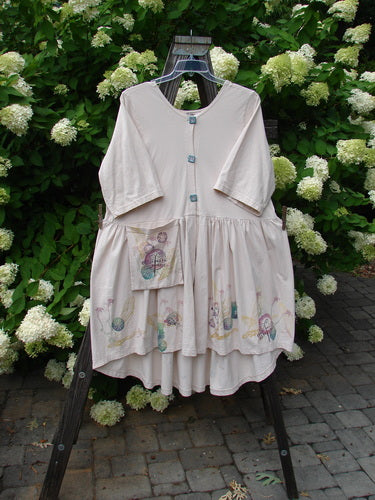 Barclay Flower Garden Cardigan Dress Dragonfly Natural Size 2 displayed on a rack, showcasing a floral design, three-button front, open lower front, and pleated skirt.