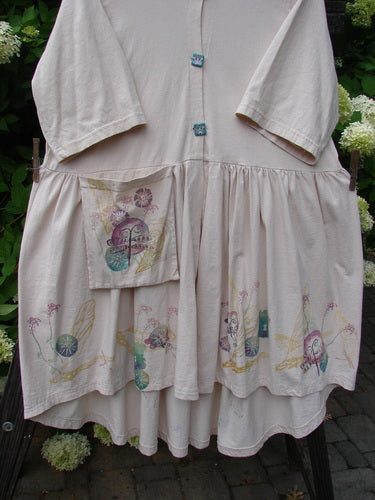 Barclay Flower Garden Cardigan Dress Dragonfly Natural Size 2 features a ceramic three-button front, open lower front, full pleated skirt, and external painted pocket with dragonfly theme.