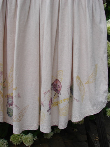 Barclay Flower Garden Cardigan Dress Dragonfly Natural Size 2, featuring a ceramic three-button front, open lower front, full pleated skirt, and dragonfly pattern, displayed on a white textile backdrop.