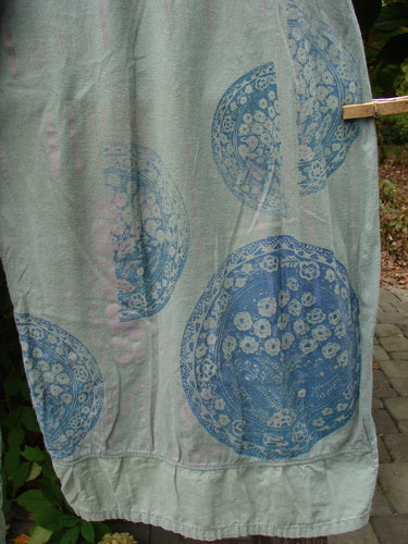 Barclay Flutter Bottom Crop Cargo Pant Medallion Vine Size 0 hangs on a clothesline, showcasing its unique blue floral medallion pattern and airy design, reflecting BlueFishFinder's vintage, creative fashion ethos.