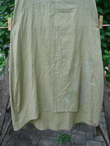 Barclay Batiste Slip Dress Floral Reach Seed Size 0, showcasing a lightweight cotton batiste fabric with a floral theme, curved empire waist, and slightly straighter shape, sways gently in a breeze.