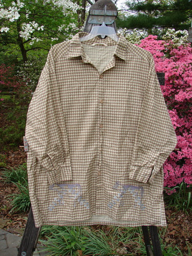 1996 Woven Tourist Top Farm Cow White Pine Gingham OSFA displayed on a hanger, showcasing its long sleeves, button front, vented sides, stand-up collar, and farm cow border design.
