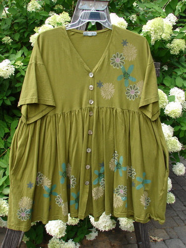 Barclay Tree Top Cardigan Dress Floral Blossom Olive Size 3: Green dress with a floral pattern, featuring a V-neckline, pearly buttons, empire waist, and flouncy gathered hem, made from lightweight organic cotton.