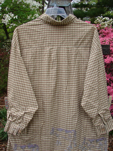 1996 Woven Tourist Top Farm Cow White Pine Gingham OSFA displayed on a hanger, showcasing long sleeves, tiny wooden buttons, vented sides, and a stand-up collar with a farm cow border theme.