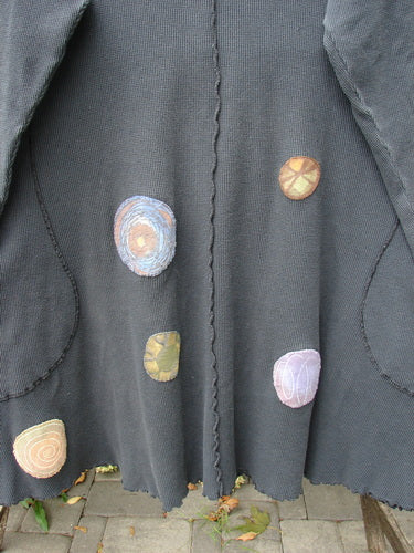 Barclay Patched Thermal Exterior Stitch Side Pocket Tunic in Off Black, laid flat, featuring whimsical multicolored fabric-appliqué circles, scalloped hem, and cozy long sleeves with curly edges, perfect for winter.