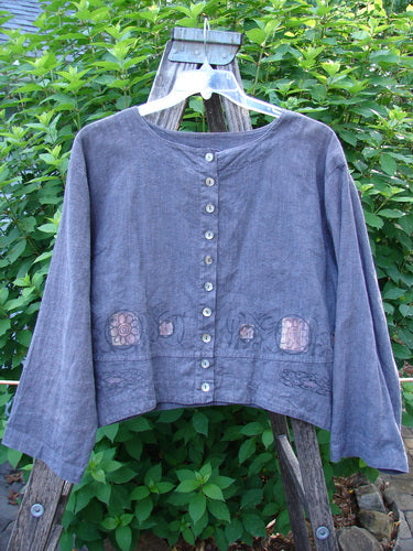 Barclay Hemp Cotton Cayman Shirt Blue Denim Circle Floral Size 0: Close-up of front shell buttons, highlighting the A-line flair and widening bottom panel with a circle floral theme, showcasing its dynamic drape.