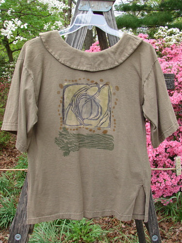 1994 Compass Top Wind Garden Bark Size 1 displayed on a hanger, featuring a pointed over collar, original buttons, and intricate Wind Garden theme paint.