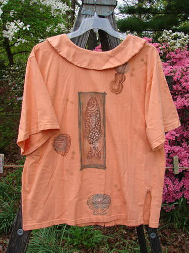 1994 Compass Top Beach Shell Music Reef Size 2, featuring fish and shell designs with a knottable elongated collar, vintage buttons, and side vents, displayed on a person outdoors.