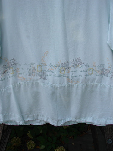 2000 Tencel Camp Shirt Airmail Shark Size 0 features a pale, lightweight fabric with a distinctive “AIR MAIL” motif, complemented by a Peter Pan collar, oversized buttons, and a drop pocket.