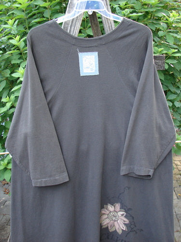 1998 Botanicals Bell Flower Top CXLVIII Raven Size 2 with belled A-line shape, upward scooped hem, rounded neckline, sectional panels, and blue fish patch, hanging on a clothesline.