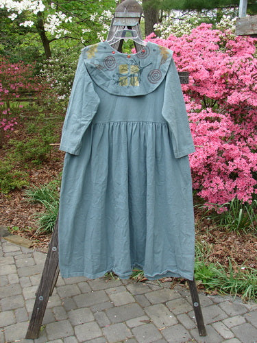 1992 Silly Collar Dress Spin Leaf Grey Green Size 1 displayed on a rack, showcasing its long length, empire waist, and wide sleeves, with a detachable painted sailor collar.