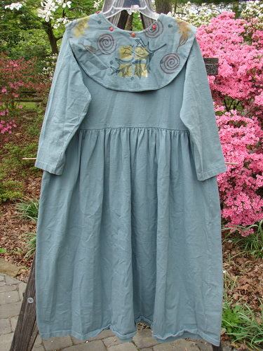 1992 Silly Collar Dress Spin Leaf Grey Green Size 1 displayed on a clothes rack, featuring a detachable painted collar, empire waist, and gathered fabric for a sweeping A-line shape.