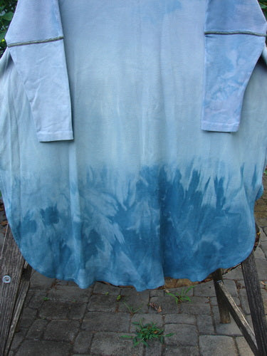 Barclay NWT Thermal Contrast Revival Top Love Dove Blue Skies OSFA features ribbed sleeves and neckline, a rounded A-line shape, side vents, and a continuous love dove theme, displayed on a wooden chair.