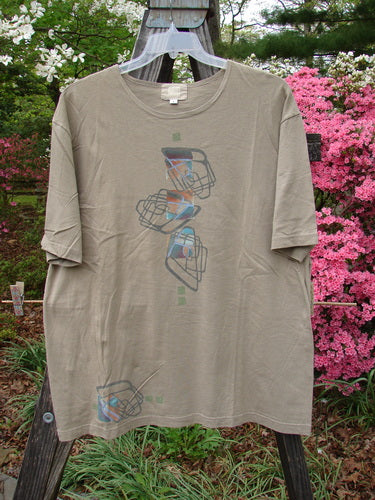 2000 Artist Choice Short Sleeved Tee Geo Dove Size 1 displayed on a hanger, showcasing a graphic design with a generous shape, drop shoulders, and slightly thinner rolled, ribbed neckline.